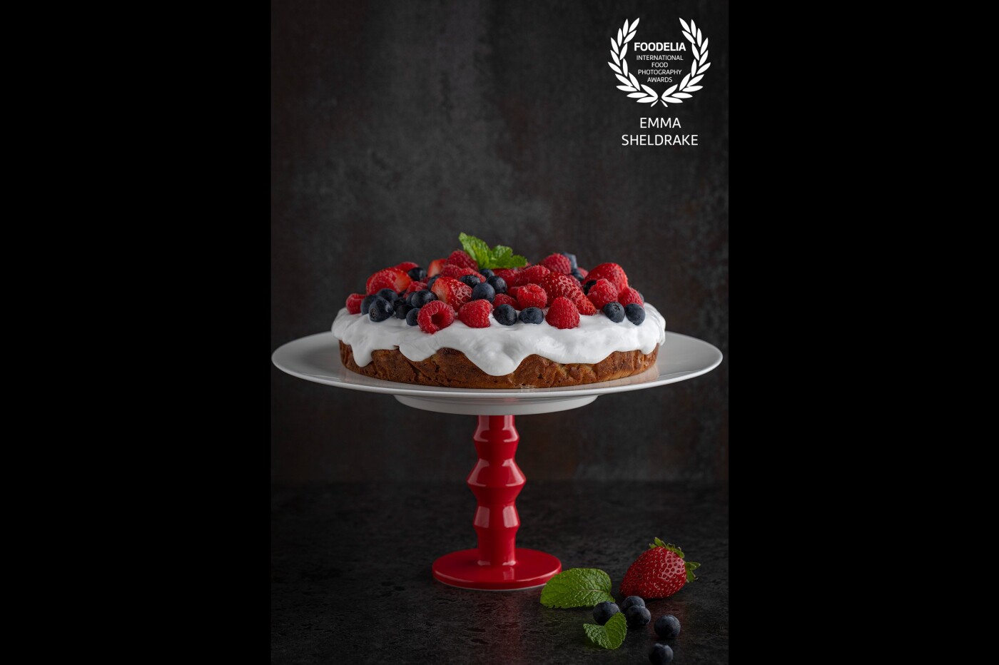 This image was from a series of images created for @changinghabits_hq ‘s new cookbook. For such a simple cake it became quite the hero on stage with dramatic side lighting and adding the red cake stand to the mix. 