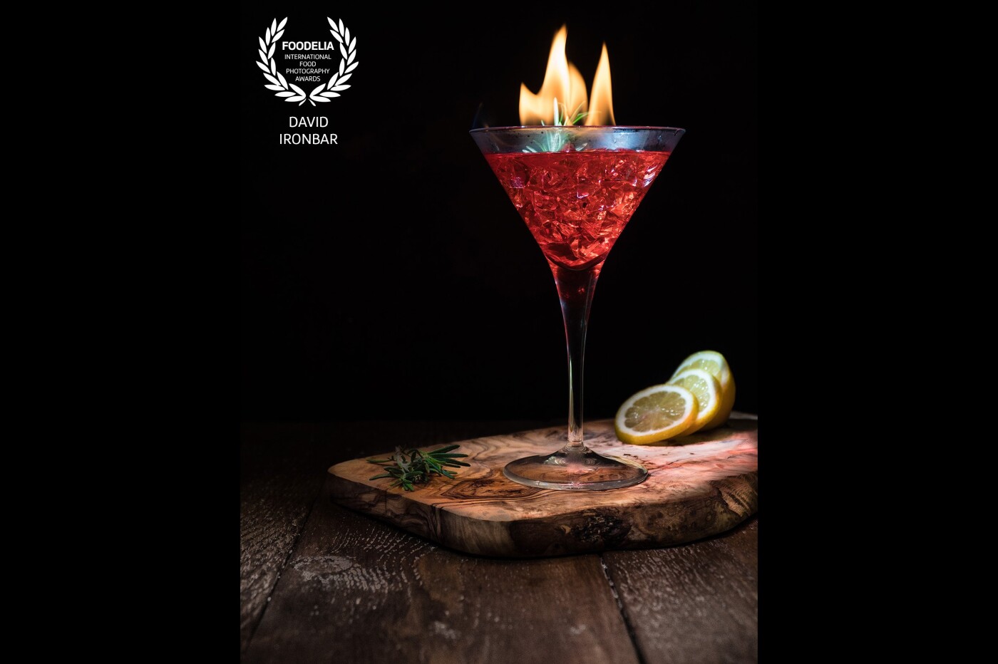 Flaming Dragon’s Blood Cocktail, consisting of Dragonberry Rum, Raspberry Liqueur, Raspberry Syrup and lemon juice, drizzled with Bacardi to get the sparkling flame.
