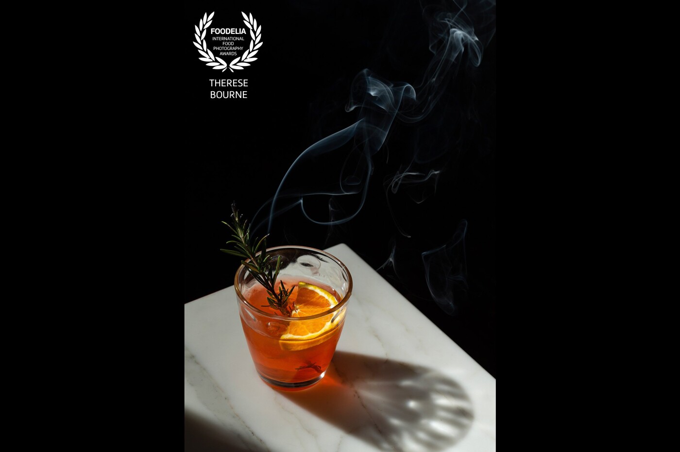 I shot this cocktail for a photography challenge. My aim was to capture the night time vibes and the drama of the shadow and the smoking rosemary garnish.