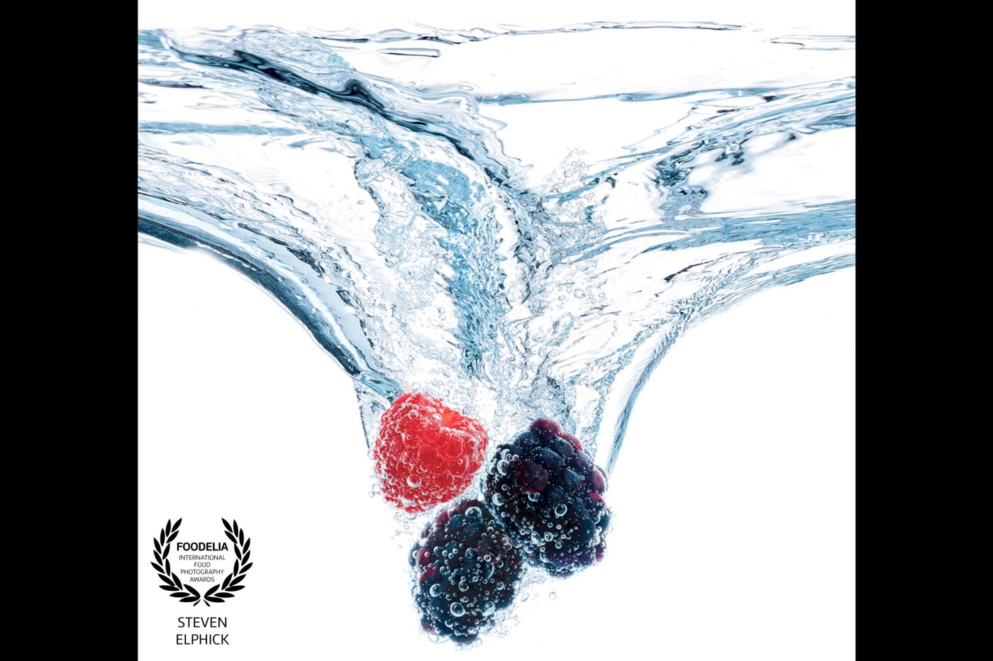 This hybrid image was created for a new unsweetened vodka-based beverage "SPLASH", a project with Sapporo of Japan.<br />
Both a large splash tank and a small bubble tank were used. Great fun was had using high-speed Broncolor flash units and Phase One medium format camera equipment. The concept required quite a variety of flavor options that featured large, heavy fruits like grapefruit down to tiny, light ones like berries.  Problem-solving required a master splash to be created to make the "sizzle" and preserve continuity in the packaging design. The flavor cues were shot separately to maximize the luscious textures and freshness of the fruits. Pre-light and test 1/2 day, shoot done in one day with a little high-speed video too.<br />
