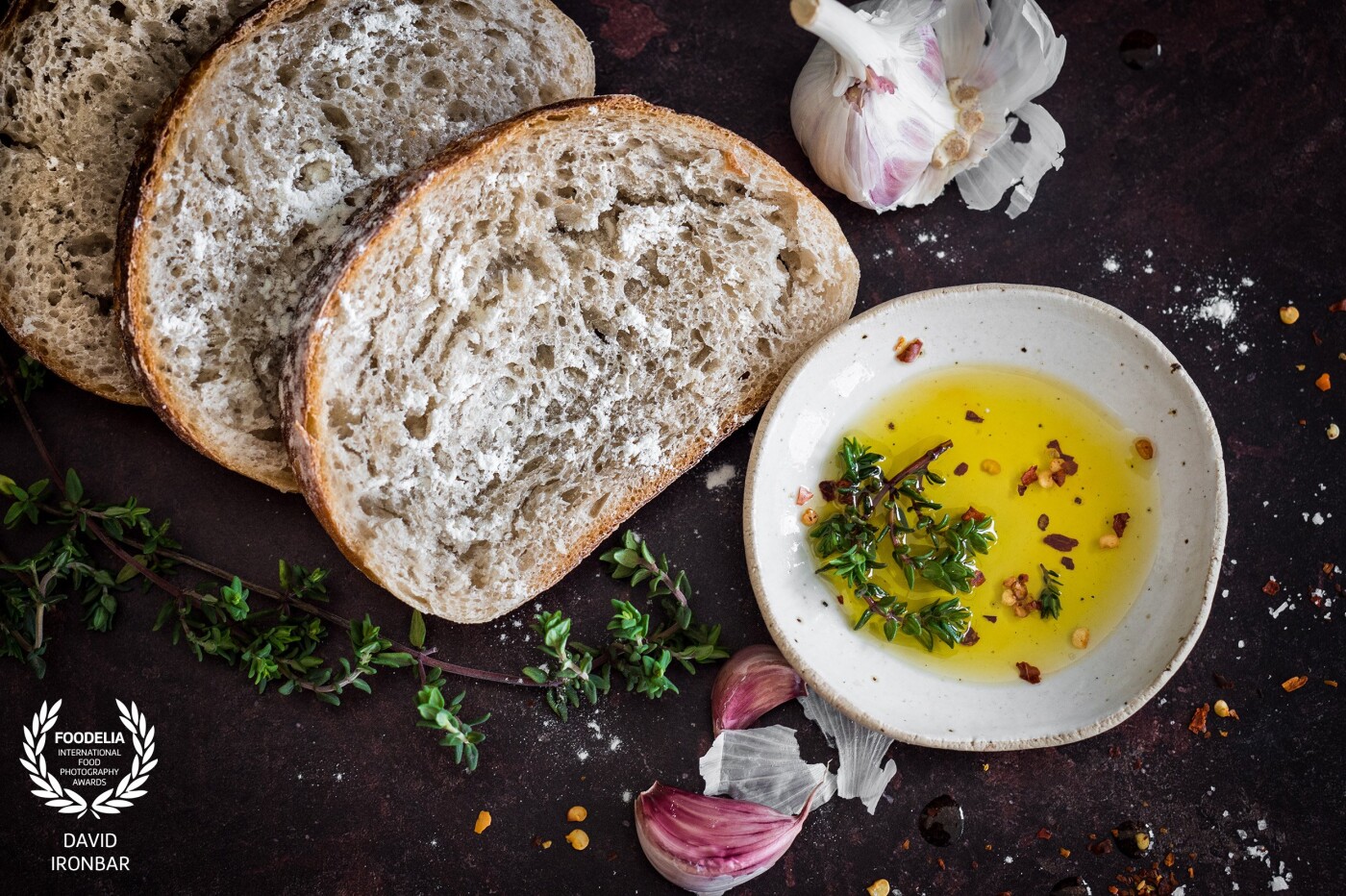 Freshly baked bread, complemented with garlic, spices, and olive oil to create a delicious appetizer. 