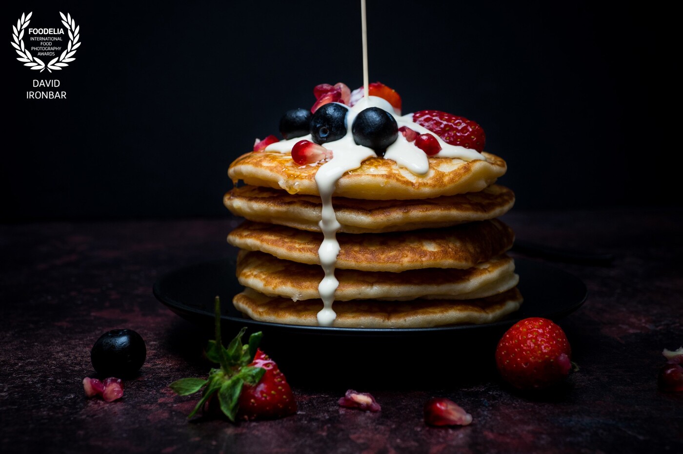 Thick, fluffy Buttermilk blueberry, strawberry, and pomegranate seed pancakes served with gorgeous maple syrup, soak perfectly into the pancakes and topped with cream.                              <br />
