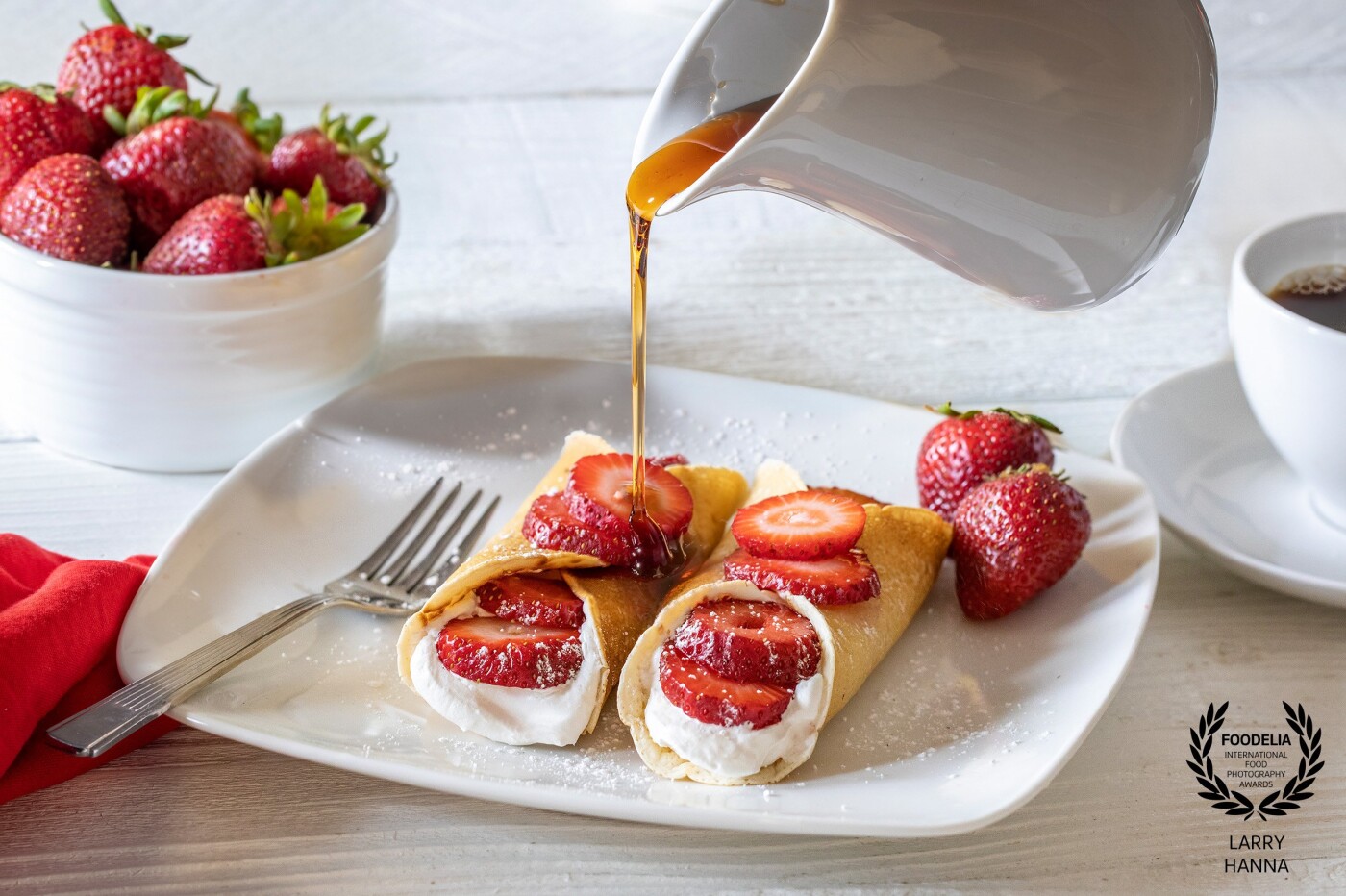 I prepared very thin pancakes and stuffed them with yogurt and sliced strawberries.  Next, the syrup was poured over them to make them even sweeter.