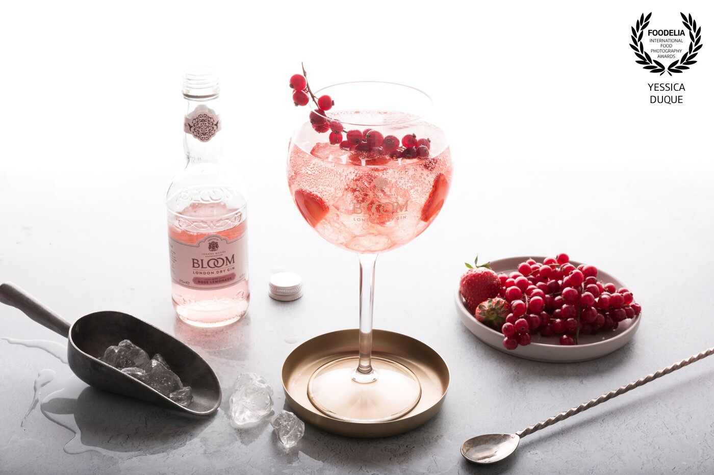 The backlight is a serious deal.<br />
I helped my self with a model light with a snoot and I finally got a shot that made me happy.  A delicious rosewater gin tonic garnished with strawberries and red berries, this made my day a happy day.
