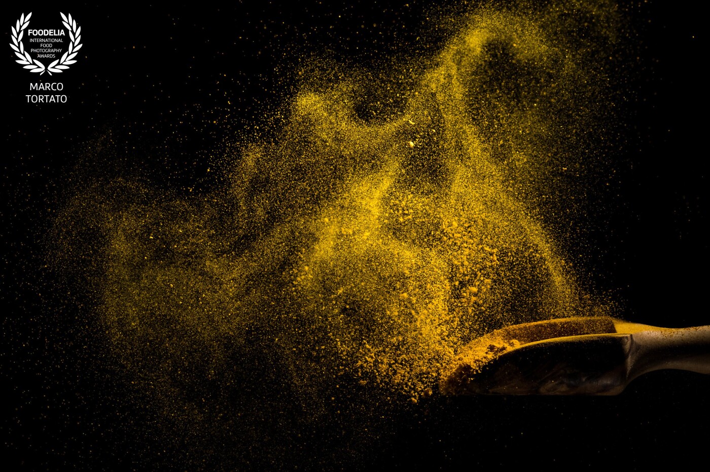 Spice burst. I love spices and I tried to let them speak and tell stories in this project of mine. Each one of them has its color, its consistency, its weight and react differently to the burst. This is curry. 