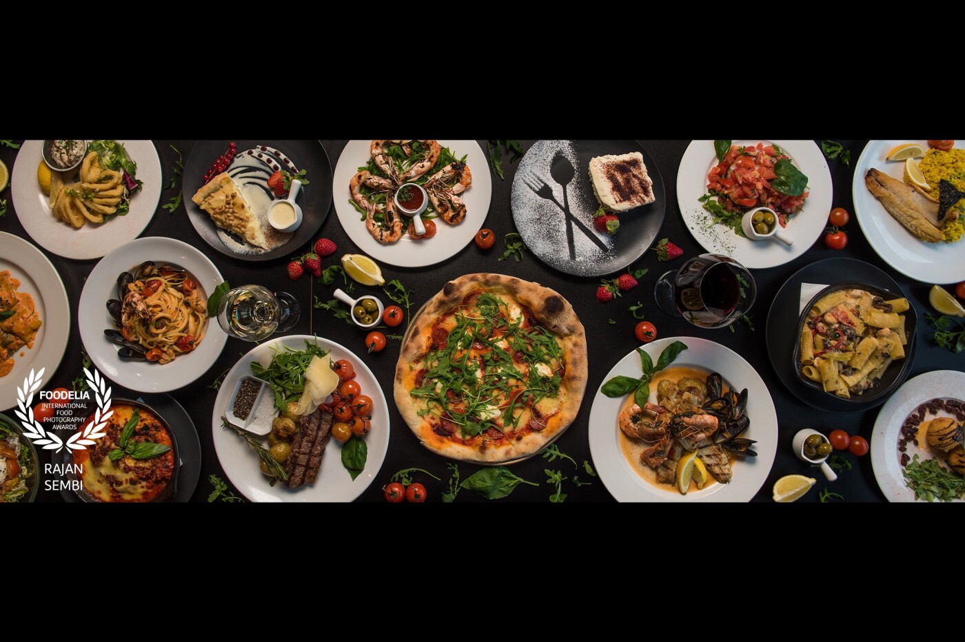 Italian Feast. This photo includes a range of modern Italian dishes including starters, mains & desserts. The dishes are surrounded by some of the key ingredients included in Italian cuisine.<br />
I used a Nikon D750 with a 24-70mm lens to shoot this.