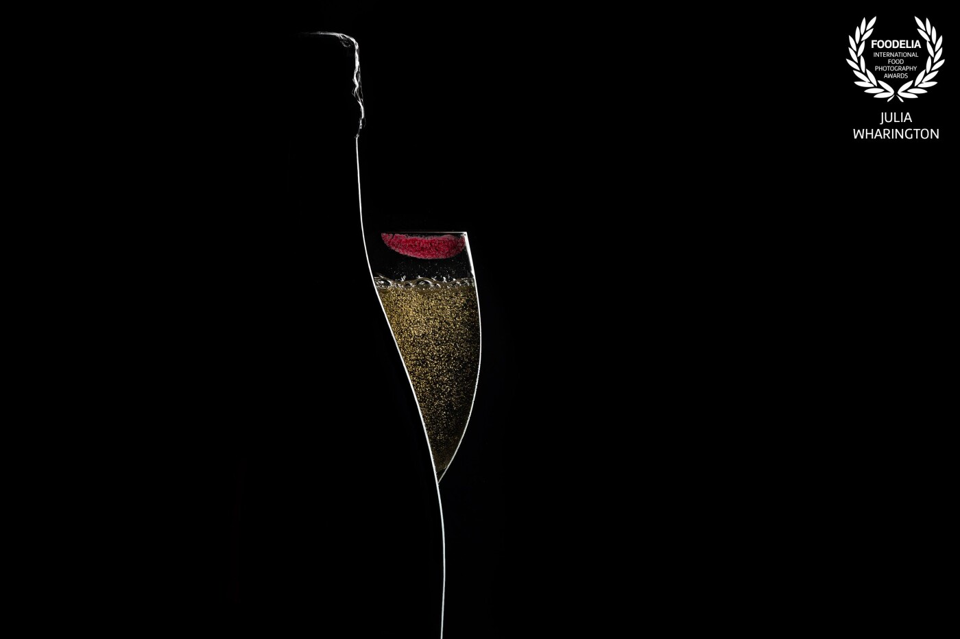 This rimlight shot of a bottle of champagne and glass was shot with one very narrow strip softbox. The placement was everything! Bubble tip: add a little bit of sugar to the drink, and it reactivates the bubbles for a few seconds.