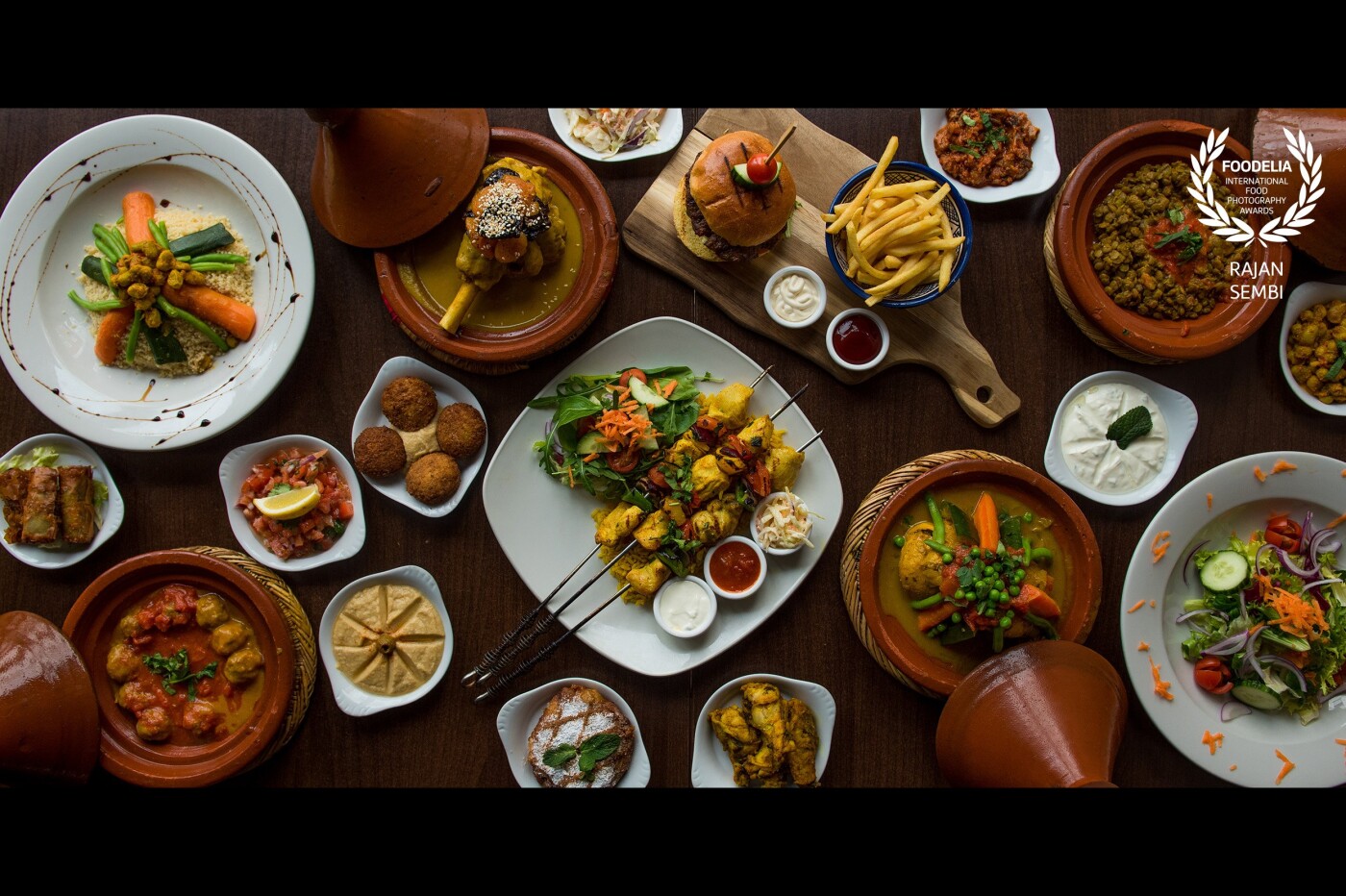 Meal from Morocco. This photo includes a range of modern Moroccan dishes including starters and mains. Using a Tajine is a key part of Moroccan tradition in their cuisine, so it was important to me to feature them in this photo.<br />
<br />
I used a Nikon D750 with a 24-70mm lens to shoot this.