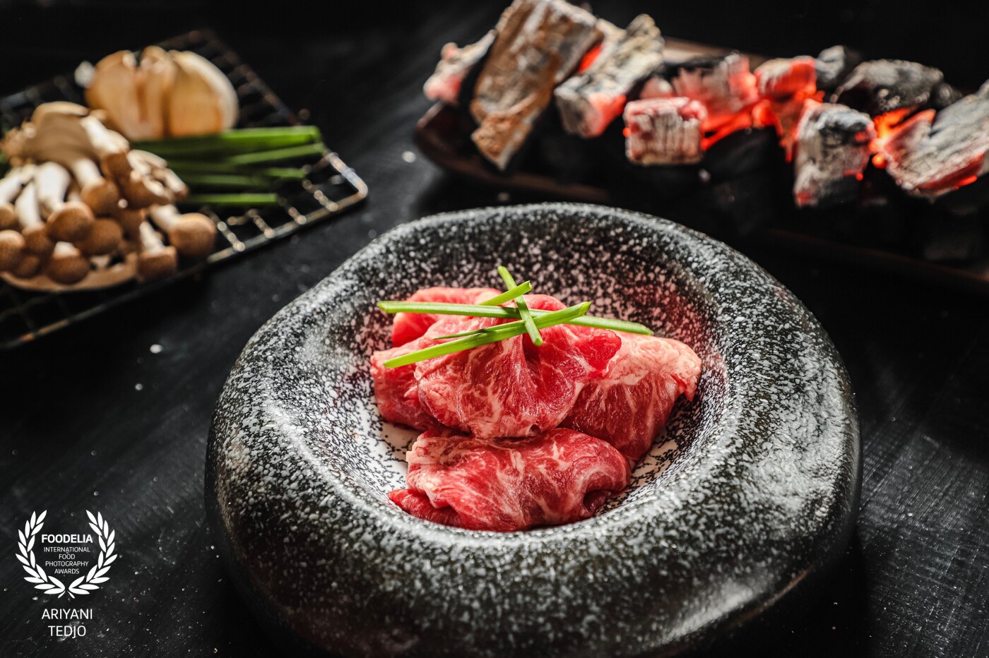 Wagyu Kiriotoshi. Japan has its premium, world-class beef variety called Wagyu. Kiriotoshi means thinly sliced of meat. This meat is superb for grilling. Some bunashimeji mushroom and garlic will definitely be included in the grill. <br />
<br />
The idea for this shot first started with the bowl that made to resemble a stone. Then I looked for an idea what to shoot this with. Upon seeing the beautiful meat in the supermarket, then I decided that it is the perfect food for the shot with the gorgeous bowl.