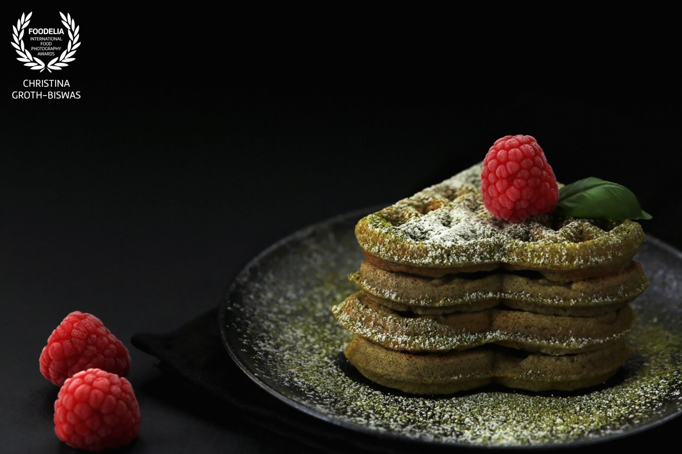 Matcha tea waffles. The subtle bitterness of the matcha tea powder contrasts the sweetness of the waffles and fruits which makes it a surprisingly light and elegant dessert.<br />
