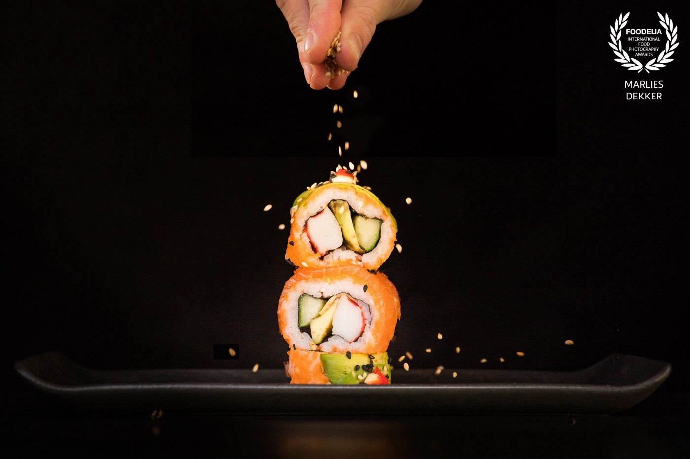 As a real sushi lover I wanted to shoot this piece of art in a typical sushi way, but with a little movement in it. So the little seeds had to do the trick :) I used a simple background (black cotton) and added some flashlights to put the sushi in the spotlight.