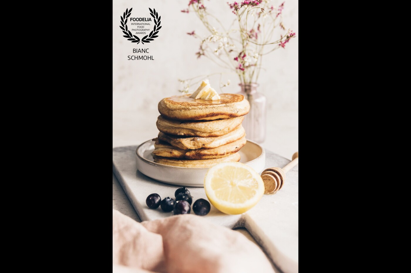 Fluffy pancakes, do we need to say more? Made a stack, just to add more depth in the photo, and made the pancake pile stand out between decoration/props like lemon, blueberries and honey stick.