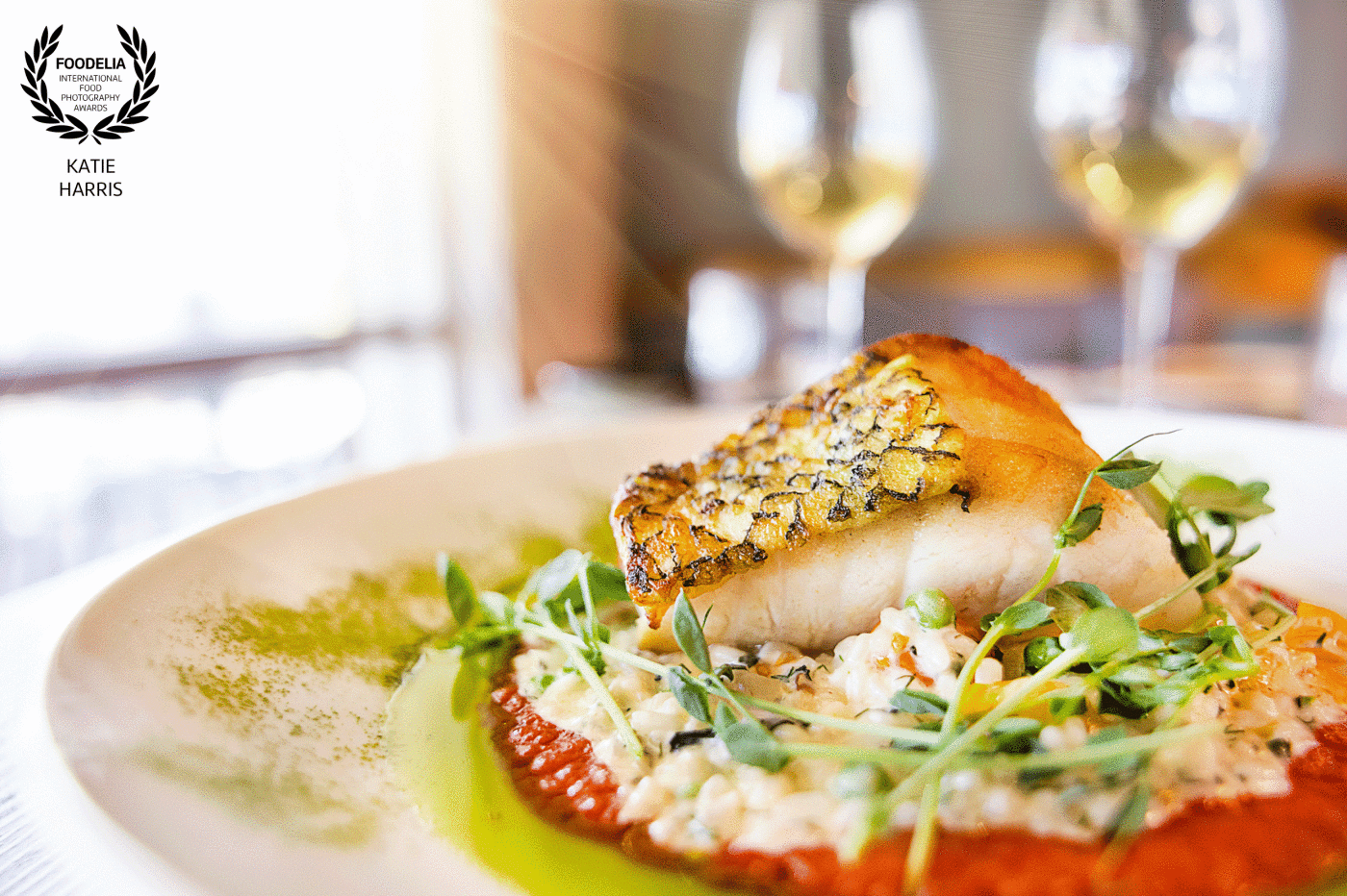 Chilean Sea Bass with spring pea risotto, pea tendrils, and basque pepper coulis by Executive Chef Justin Hayes with Cork & Flame in Evans, GA.