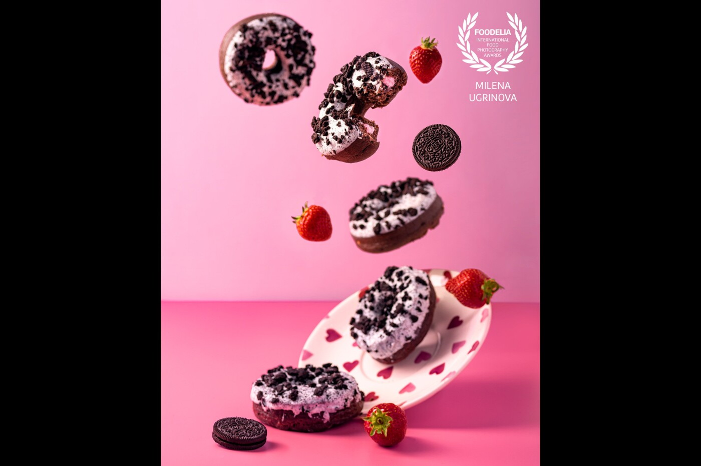 Oreo doughnuts with strawberry flavoured cream. An explosion of sweetness. The photo is made at once, cleaned from the sticks and strings with some corrections of the colours to get the desired pink tone.