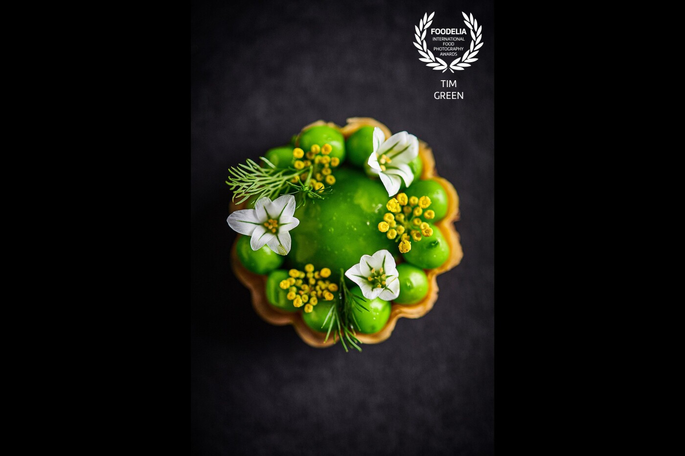 Pea Panna Cotta dipped in Pea Juice, Compressed Peas in Wild Garlic Oil and garnished with Leek and Fennel Flowers. One of the amazing snacks presented by Adam Handling of The Frog Covent Garden London.