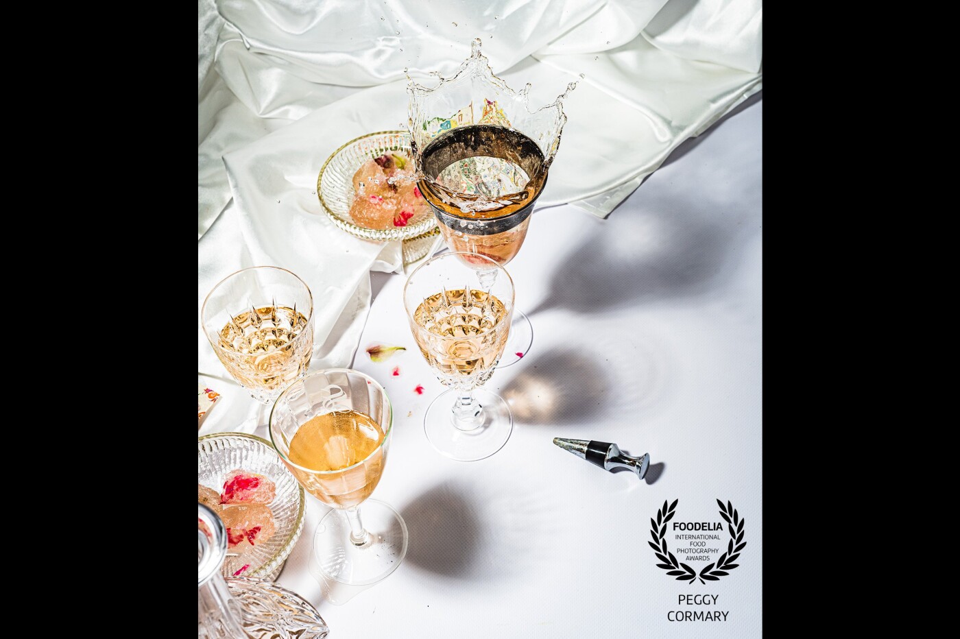 Some antique French wine glasses with some dynamic visual effects, splash and shadows .As an invitation to a celebration for a social gathering.