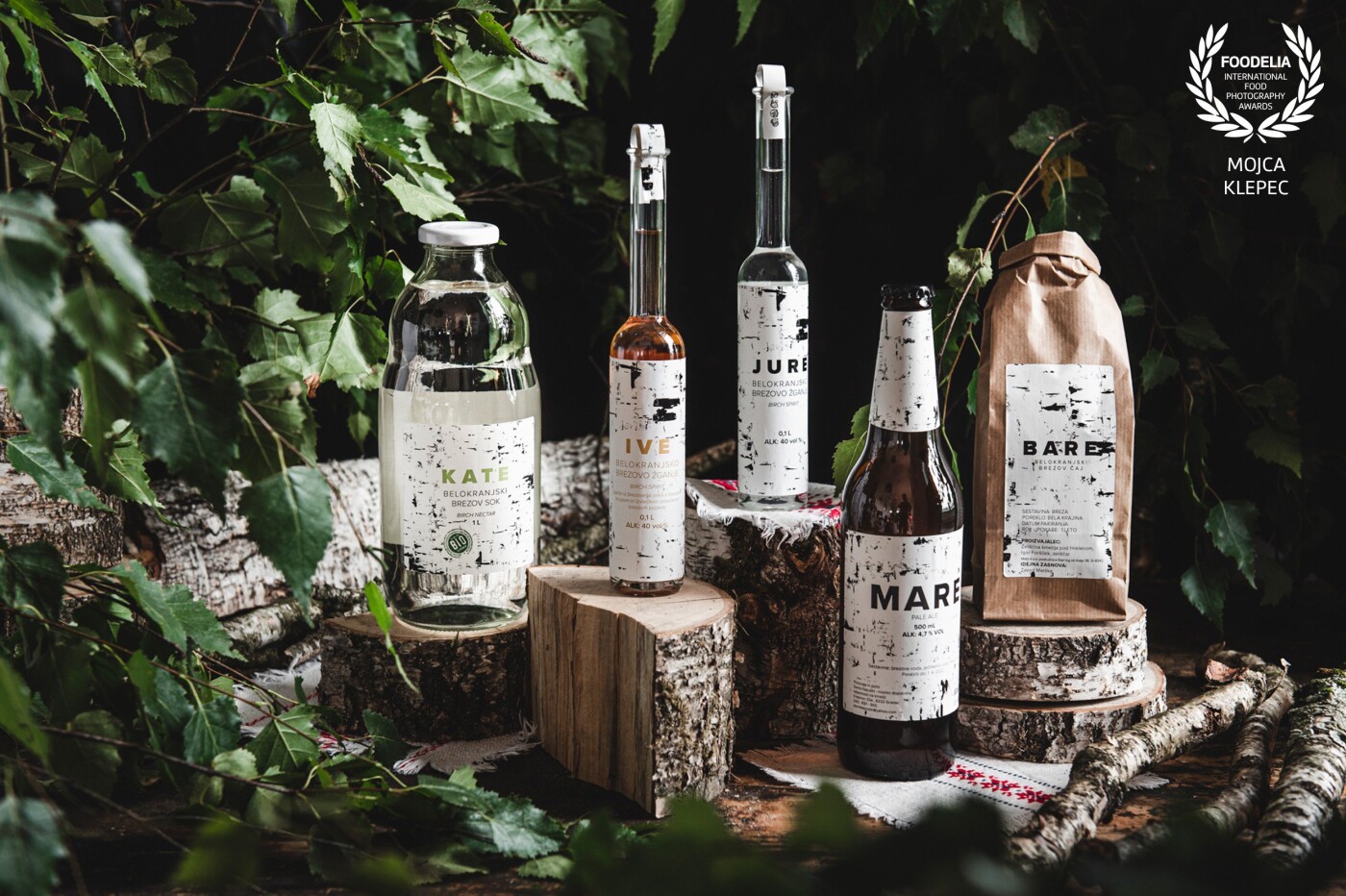 Slovenian region Bela krajina is known for birch trees. What better way to present products made from birch as to make a scene using birch wood and birch leaves and some traditional napkins from the region. Client: https://hisadobrot-belekrajine.si/