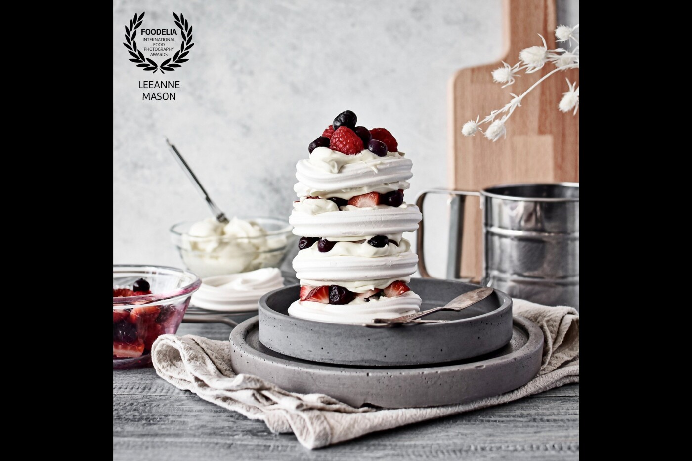 I believe storytelling is truly important in food photography.  When constructing this Pavlova tower, the detail of the meringues and berries were beautiful as they were so when I built the background layers I wanted to ensure the colours and composition did not distract from the main subject, rather draw your eye to it.