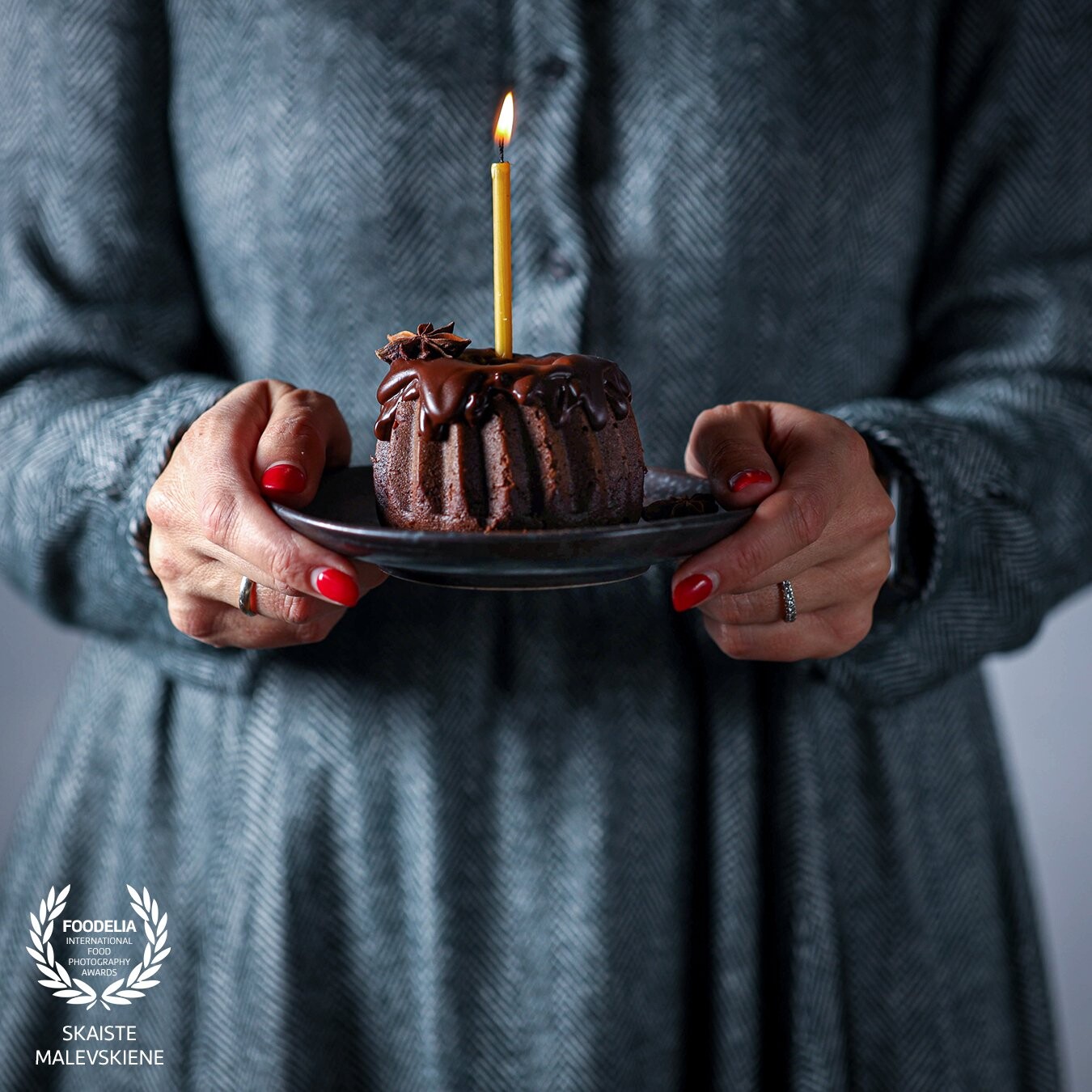This is a mini chocolate bundt cake and a sweet little candle and me making my 40th birthday wish. With the help of my husband and my elder son I was able to freeze the moment.