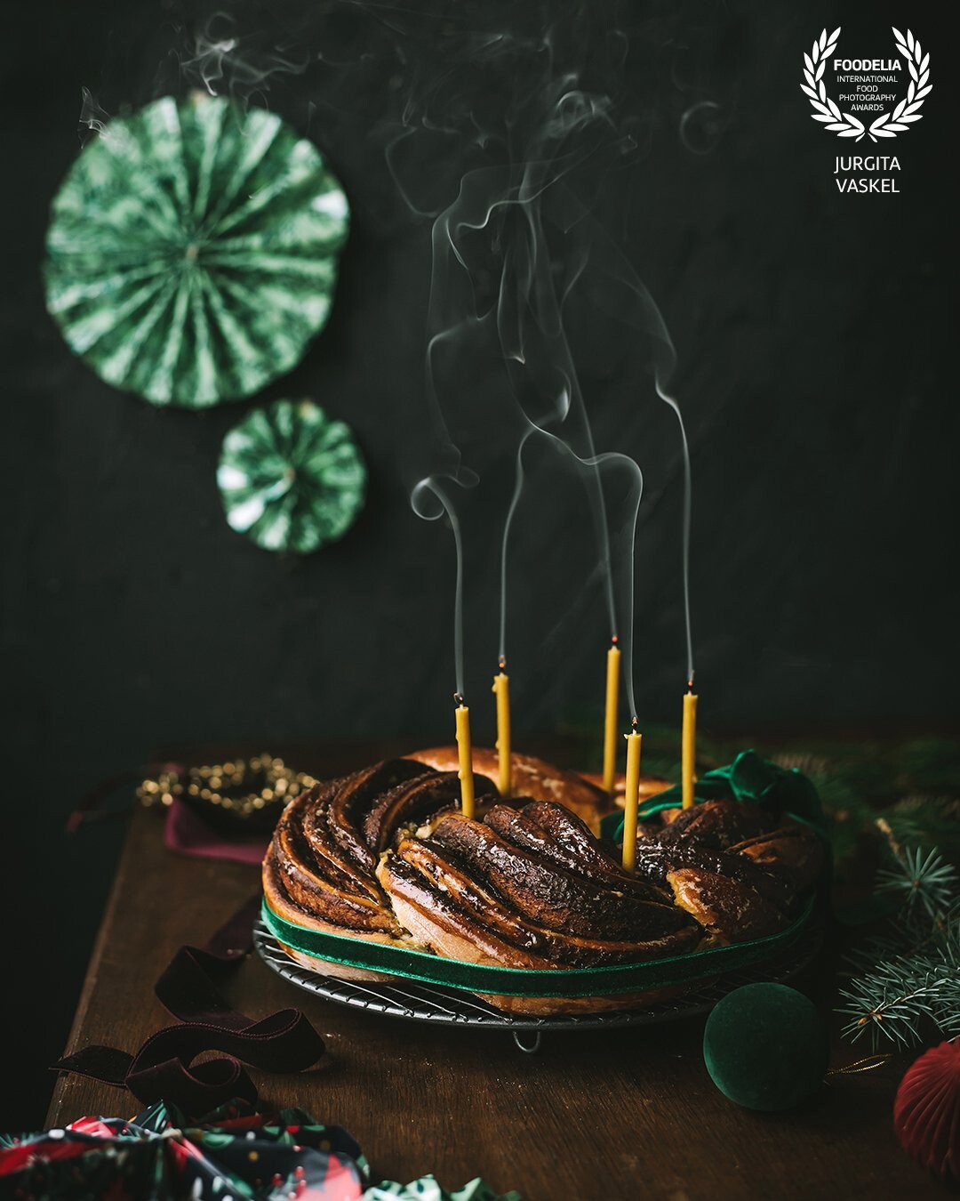 I would call this picture "Still life with chocolate Christmas wreath and magical swirls of smoke". Smoke adds depth to the shot, as well as life and energy.