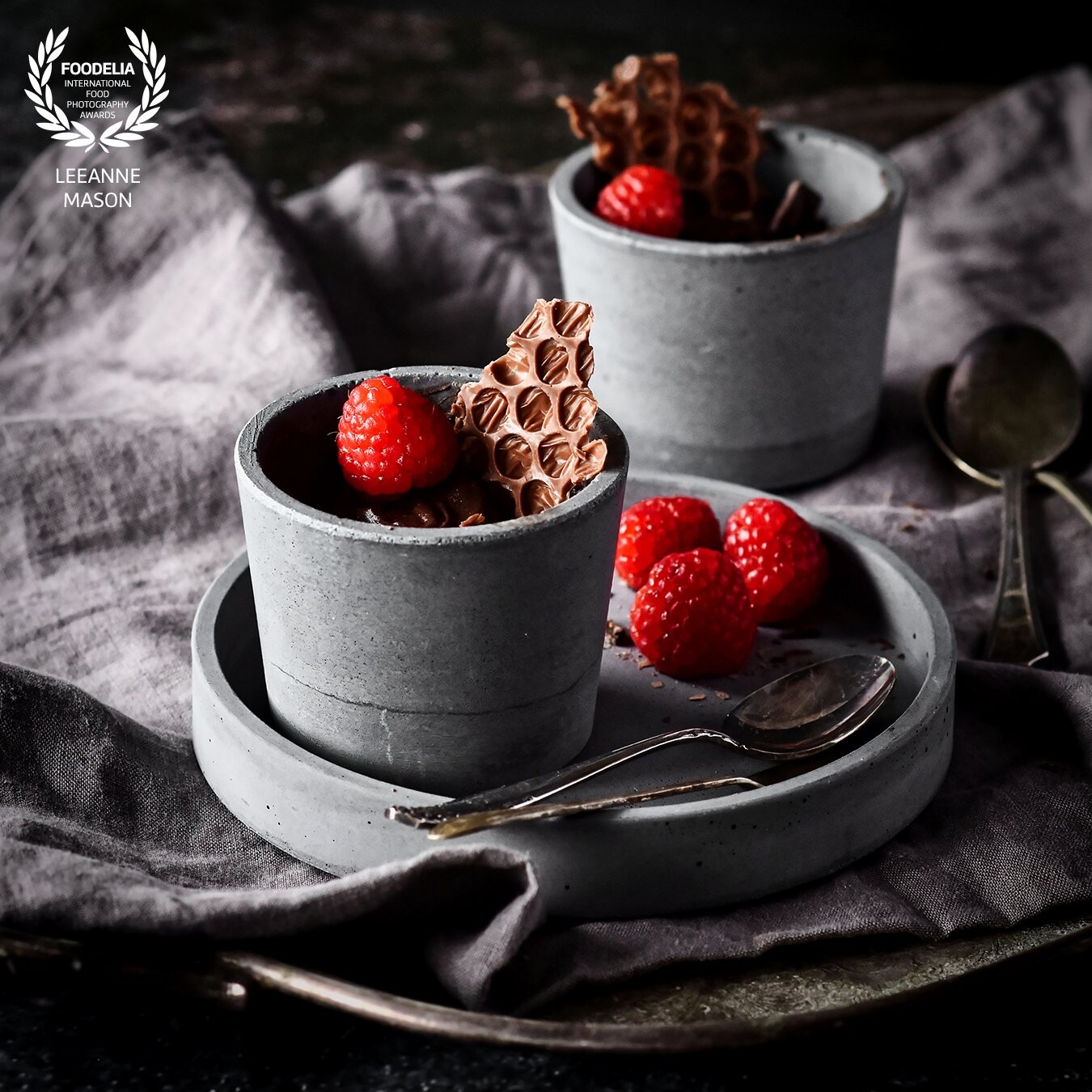 I love capturing the unusual and when I found this Chocolate Bubble Wrap recipe it was a perfect fit for a delicious chocolate mousse garnished with raspberries.  The the pots and plate added texture and a cool colour palette to the image.