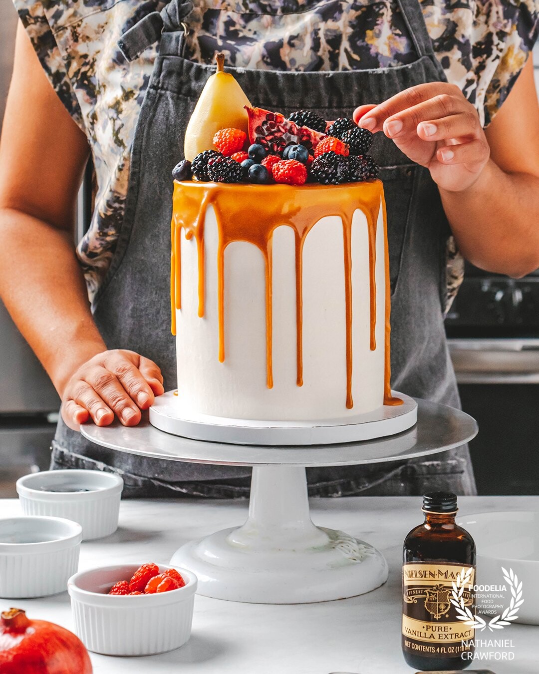 This is a capture from a recent client photoshoot for Nielsen-Massey Vanillas. Jessica of Jessica's Dessert Studio (in Chicago, IL) was brought in to build and decorate this layered cake, adorned with fresh fruit, poached pear, and dripping caramel sauce.