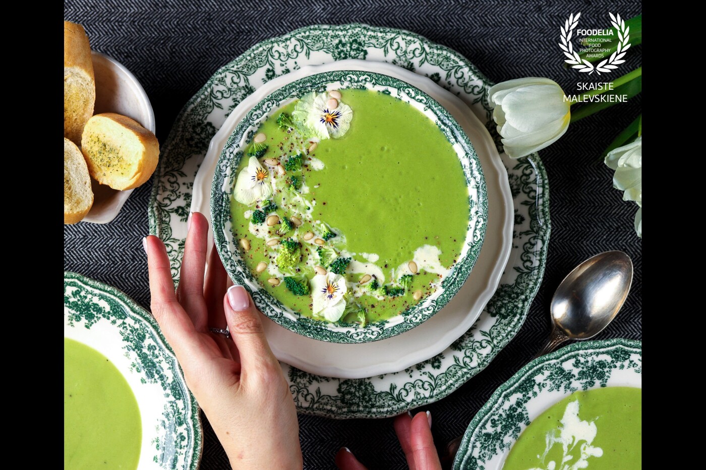 Beautiful and delicious broccoli soup styled with cream, edible flowers and pine nuts goes along so well with these magical green plates.