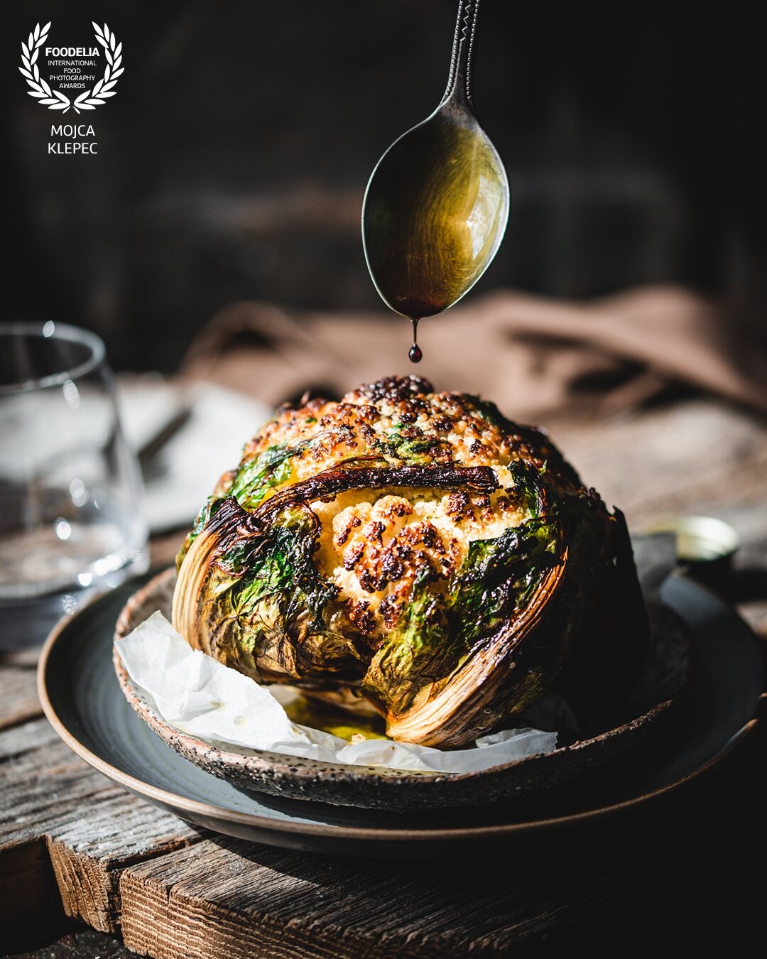 Whole roasted cauliflower served with a few drops of high quality pumpkin seed oil makes a perfect starter or main dish. <br />
Photo taken with a natural light, client work.