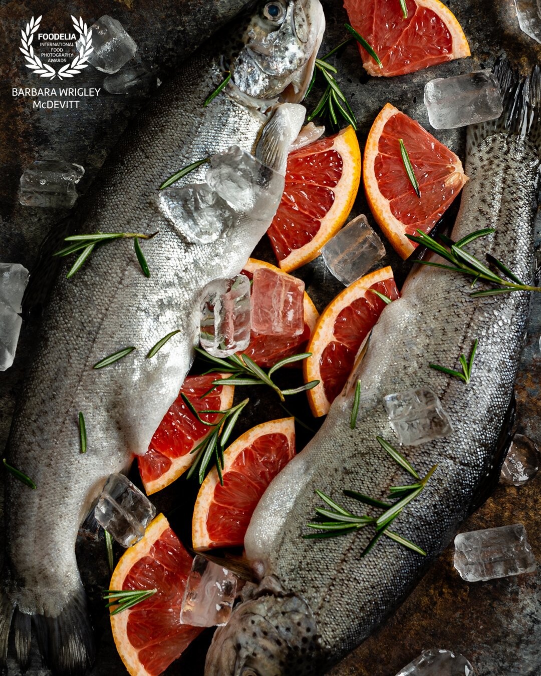 Ruby red grapefruit pairs nicely with sprigs of rosemary and adds a tart citrusy flavor to a pair of branzino.  Shot with a Nikon D850 and Profoto B1.