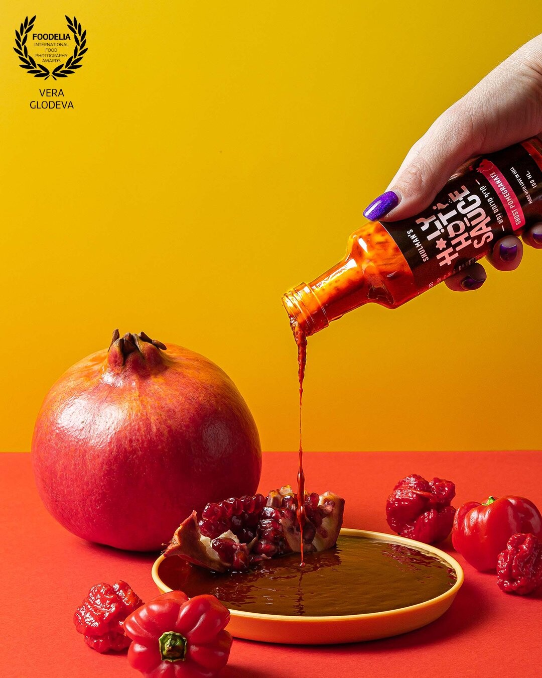 This photo shows us the combination of a magnificent pomegranate and an incredibly hot habanero peppers, which form a sauce with a spicy level of 350,000 SHU. I wanted to capture this spiciness with a drop coming out of a bottle and a plate full of sauce, which create the association of blood as something dangerous.