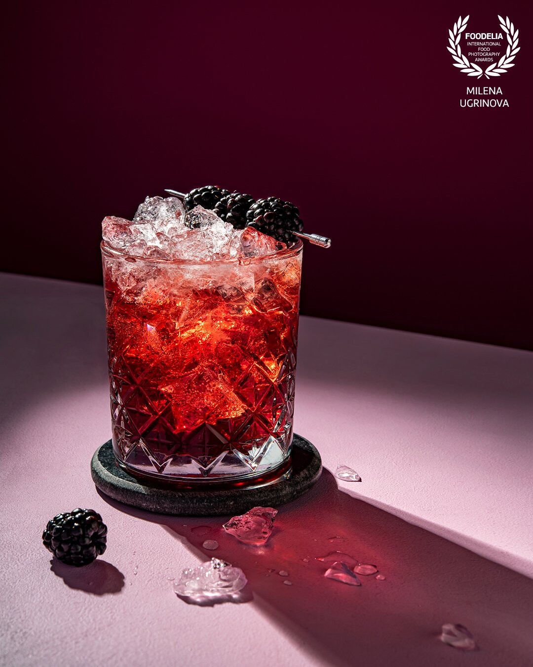Blackberry Bramble is a very passionate cocktail to bring you up. Its flame red is remarkable in combination with the ice-cold.<br />
<br />
The photo is being a deep investigation into the light and the semi-transparent character of the ice-filled drink. It is created with a single light source, a small 7" standard reflector and a honeycomb.