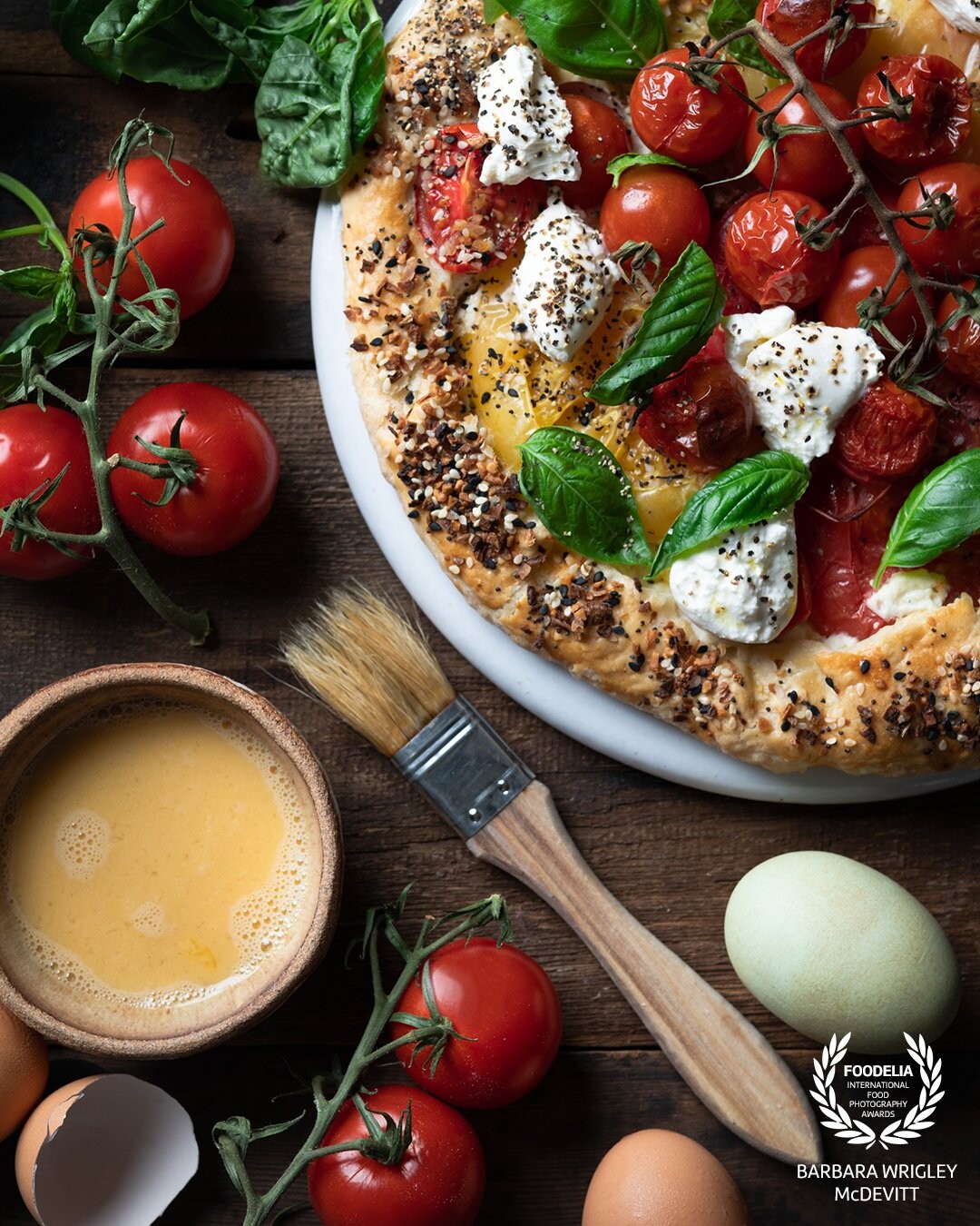 There is nothing better this time of year than a fresh tomato galette.  This galette was made with fresh tomatoes, fresh ricotta, egg and parmesan cheese (as the base) and then topped with burrata, pepper and fresh basil.  Egg wash was added to the crust for the golden look.  Shot on a Nikon D-850 and a Profoto B10+.