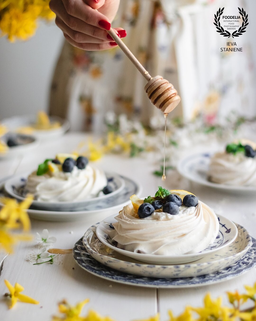 Pavlova is such a beautiful dessert. I wanted to capture these mini Pavlovas in a springy atmosphere so I’ve chosen bright and vibrant colors for this shot. Movement and complementary color scheme helped to add some contrast and make the scene a little bit more intensive.