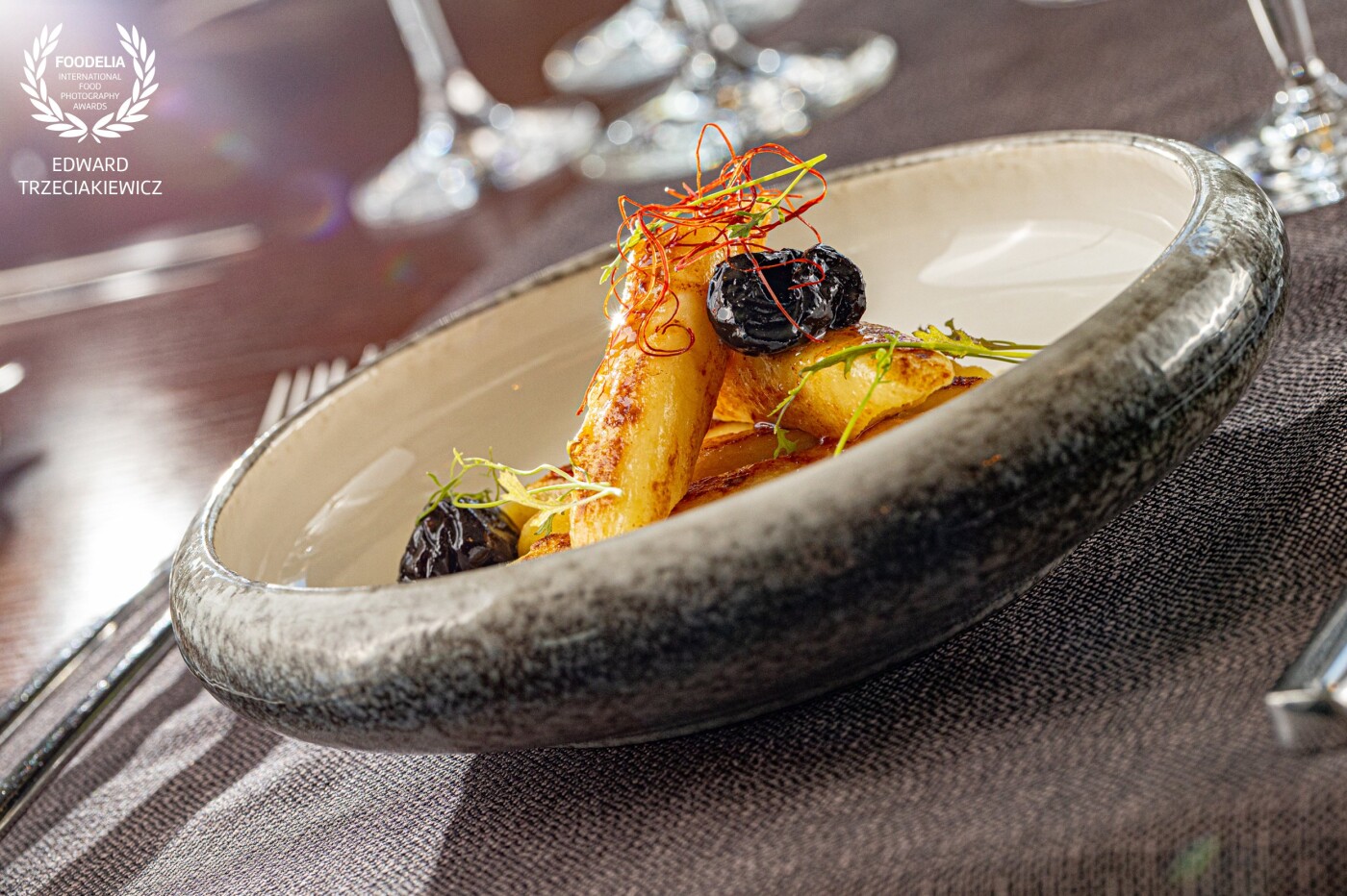 Dumplings with cottage cheese, Hungarian plum, chilli threads, flamed on tincture of pine shoots.<br />
Chef:<br />
Michał Soliwoda<br />
Hotel Mikołajki - Mikołajki - Poland
