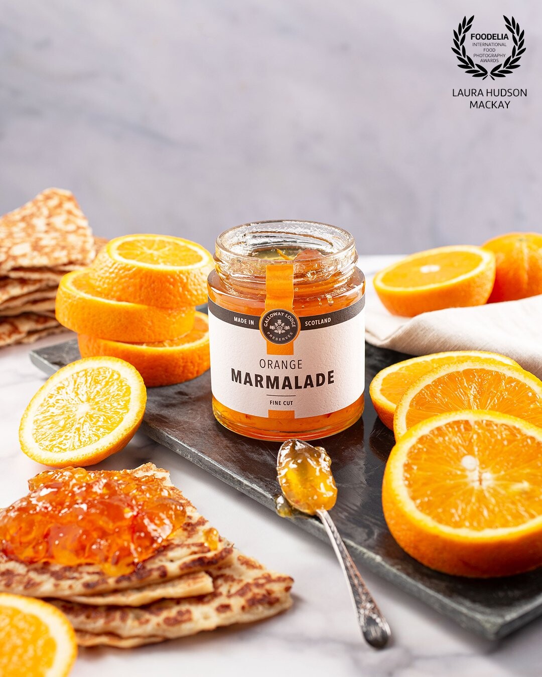 Super fresh and tangy, nothing beats this orange marmalade spread on top of warm pancakes. I chose muted tones for the surface and props which helps the oranges and the marmalade POP!
