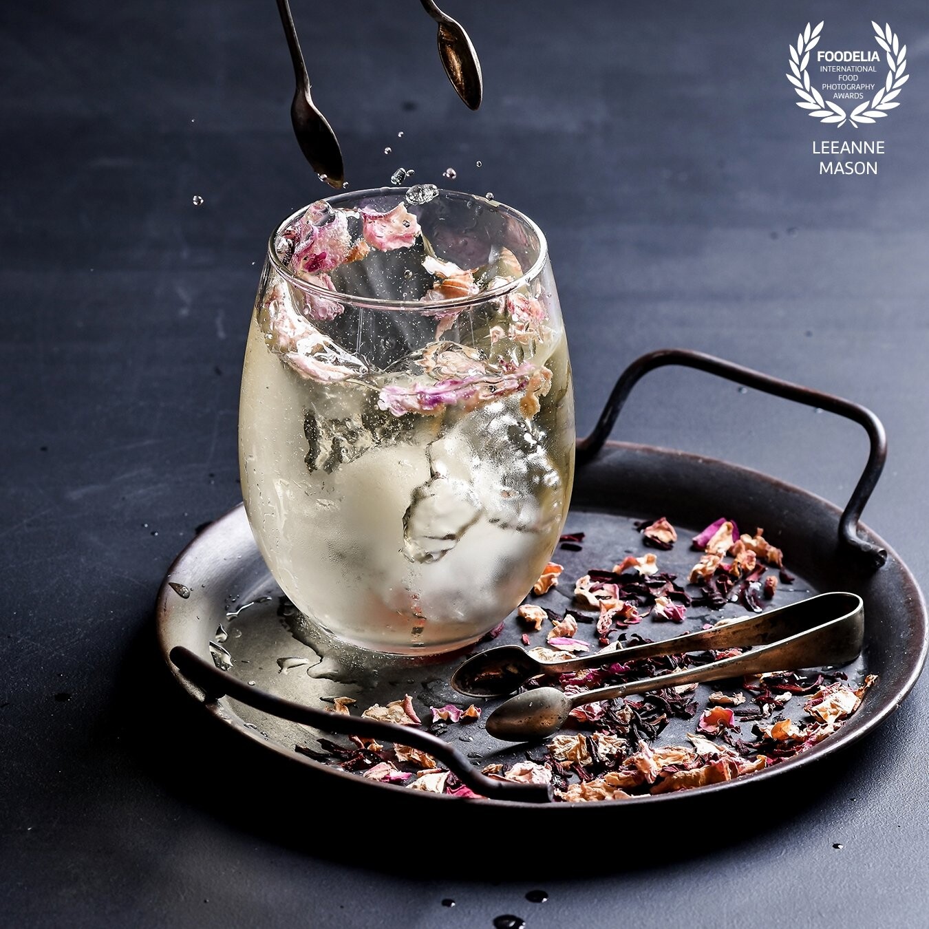 I created this Drinks Splash image with a Godox AD300 from behind and slightly off to the side.  I used Altina Drinks non alcoholic white wine and ice cubes containing rose petals as the subject and by using continuous shooting mode I had a few options to choose from.