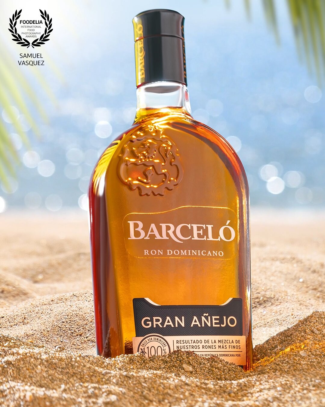 Made entirely in studio with real sand and a tv screen for the background. Palm leaves were added in post but we had them on set to create the reflections on the bottle.