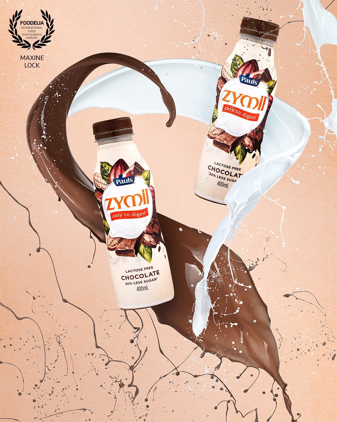 Chocolate milk bottles surrounded by splashes of chocolate and splashes of milk, with the splashes surrounding the bottles and creating a bit of a "mess" effect on the sides of the image.