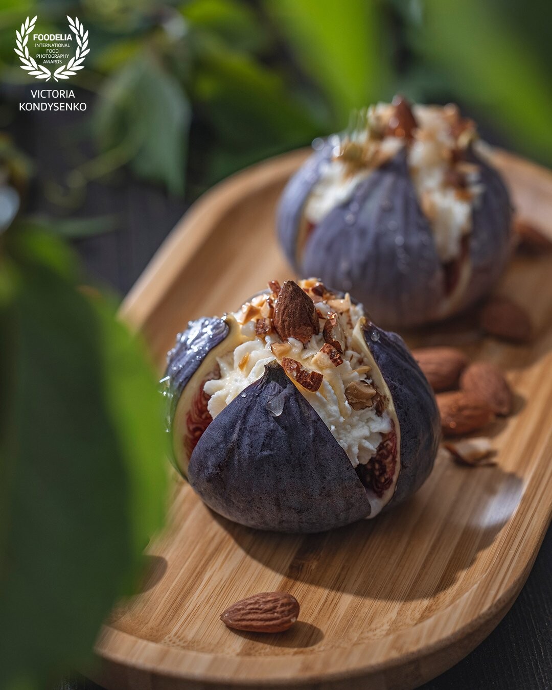 Fresh ripe raw figs with mascarpone cheese, almonds and honey or maple syrup in wooden tray.  Sweet food ready for eat. Unsurpassed taste of autumn.