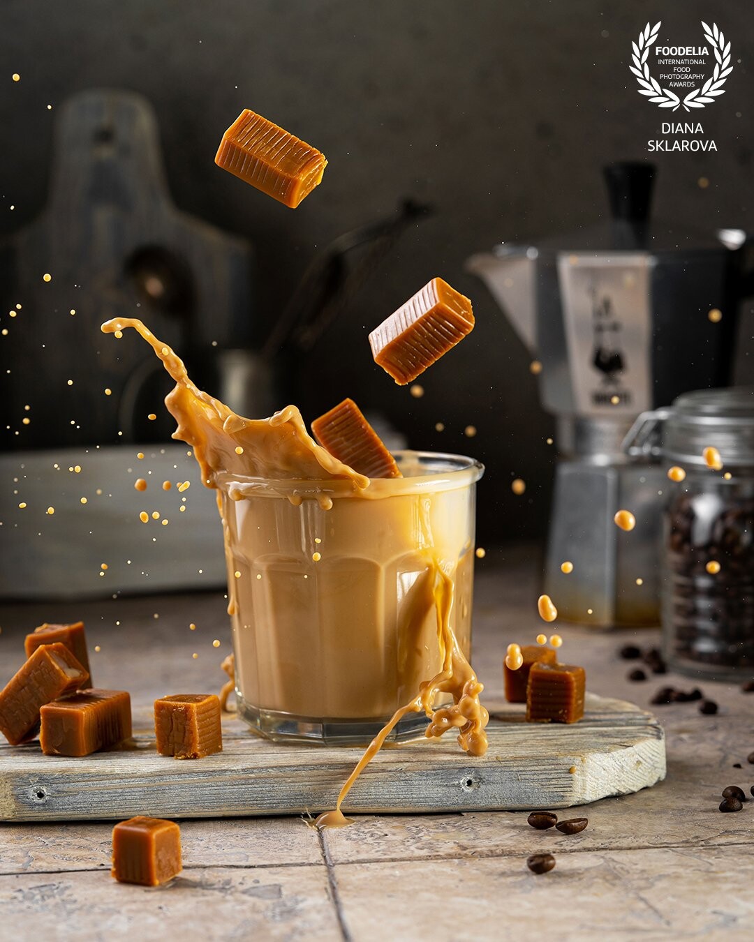 Toffee coffee splash with candy levitation with droplets in the air. Homemade delicious  dessert drink. Beautiful conceptual art photography
