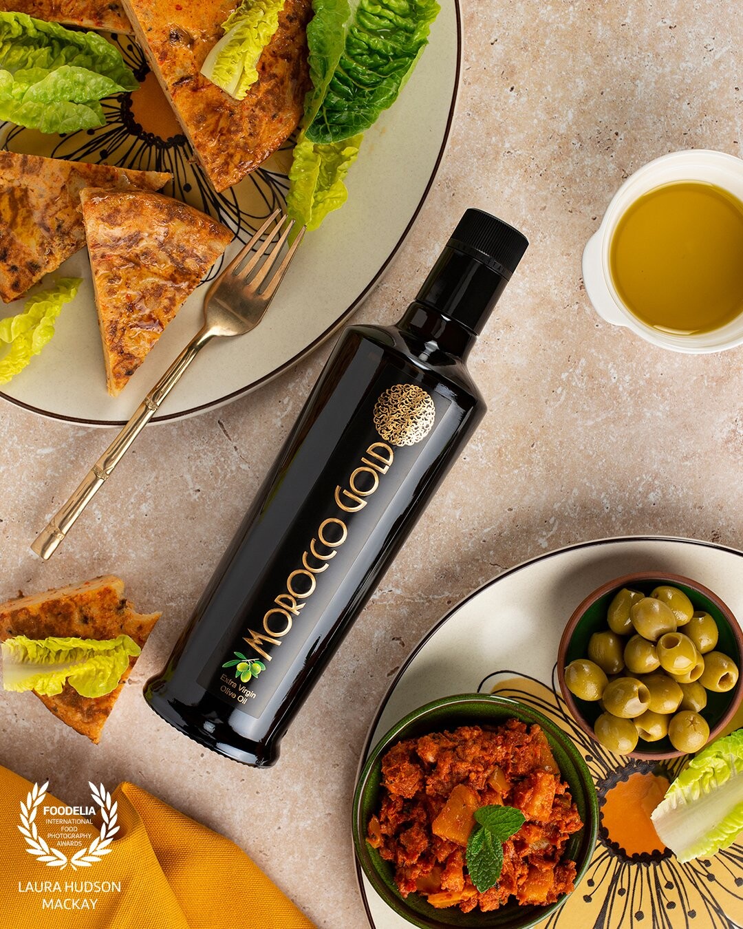 Delicious egg, potato and onion tortilla cooked gently in olive oil and served on cheery plates that POP! Photoshoot for Morocco Gold, award-winning luxury extra virgin olive oil.