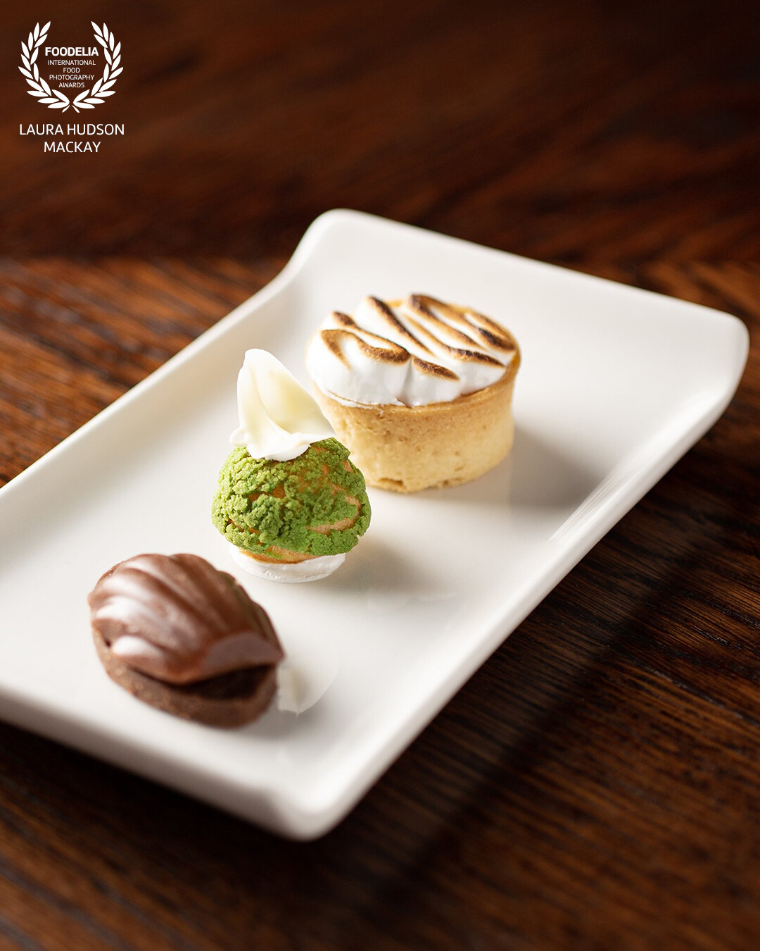 Passionfruit meringue pie, pistachio choux and salted caramel and peat fudge. A trio of delicious treats presented by the chefs at The Globe Inn, Dumfries, Scotland