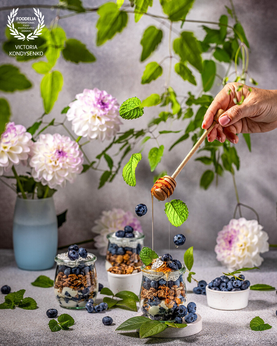 Homemade granola with greek yogurt and fresh blueberries in glasses. Advertising photo shoot of the local Ukrainian family cafe