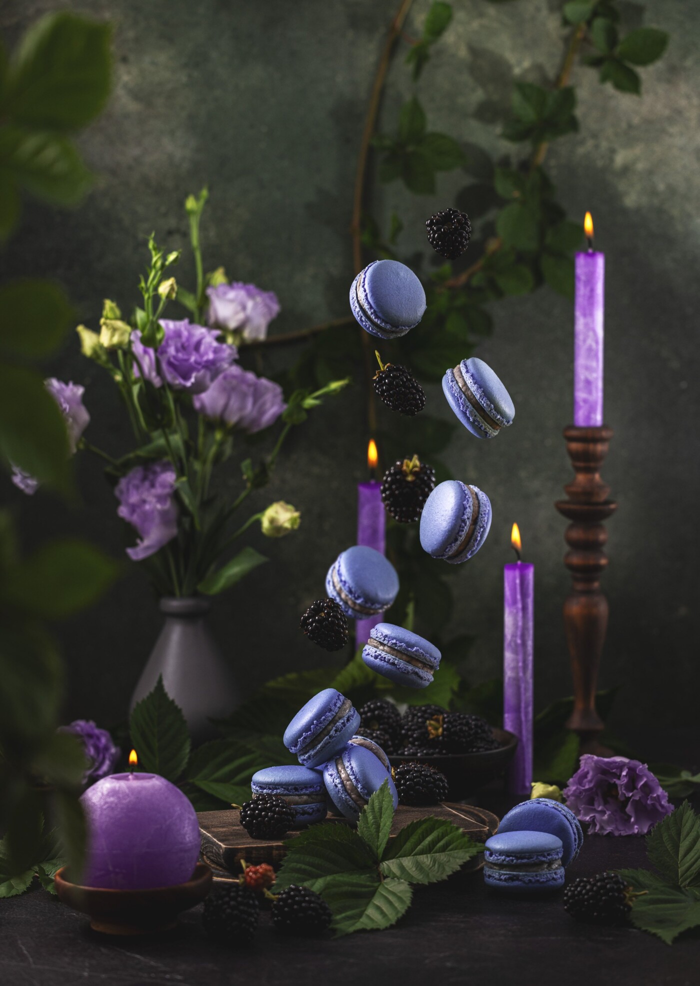 Violet macarons and blackberries surrounded purple candles and Eustoma or lisiant. Macarons is a ver...
