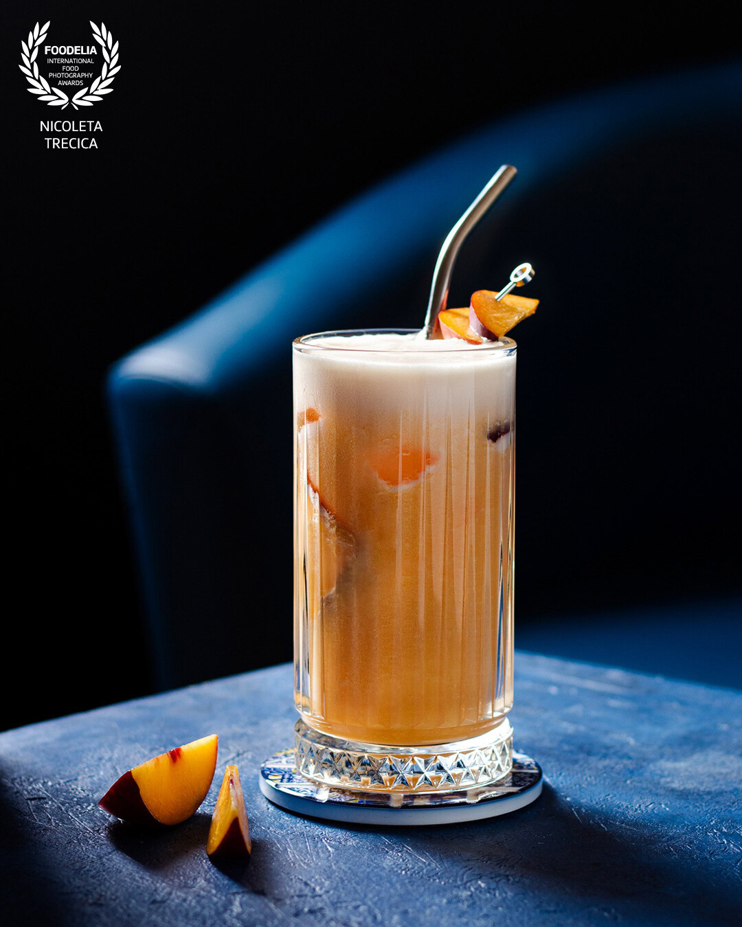 The idea of this image was to create a cosy atmosphere in a pub. The colours of the surrounding set the perfect backdrop and contrast for enjoying this delightful, fruity cocktail.