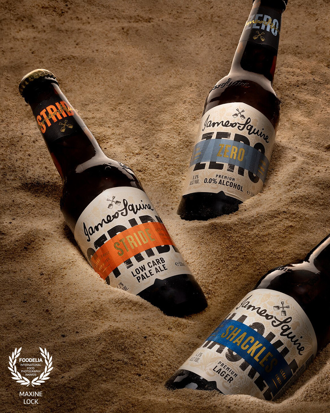 A selection of beers buried as treasures in the sand.