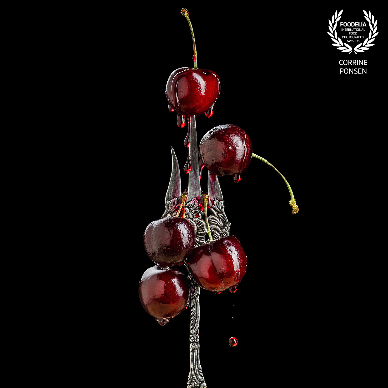 I shot this image of dripping cherries on a fork for my qualification to became a Silver Master Photographer (and it was succesfull).<br />
<br />
I shot it with 2 flashes and the drops are colored honey. I find the vintage fork in a second hand shop.
