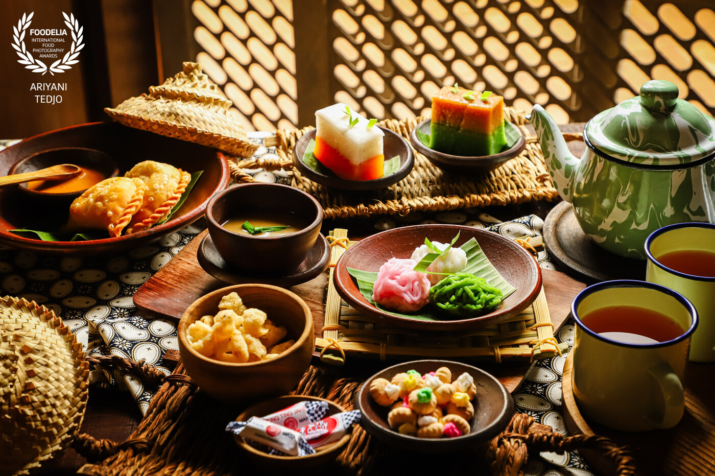 Traditional afternoon tea. Portraying popular lndonesian snacks served for an afternoon tea here in Jakarta, served on earthenware crockeries and Javanese enamel tea set.