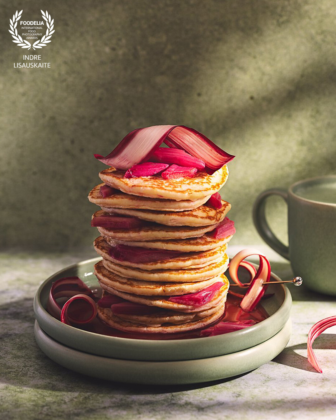 Golden pancakes stacked high, layered with tender rhubarb — a sweet reminder that simple moments can feel indulgent.