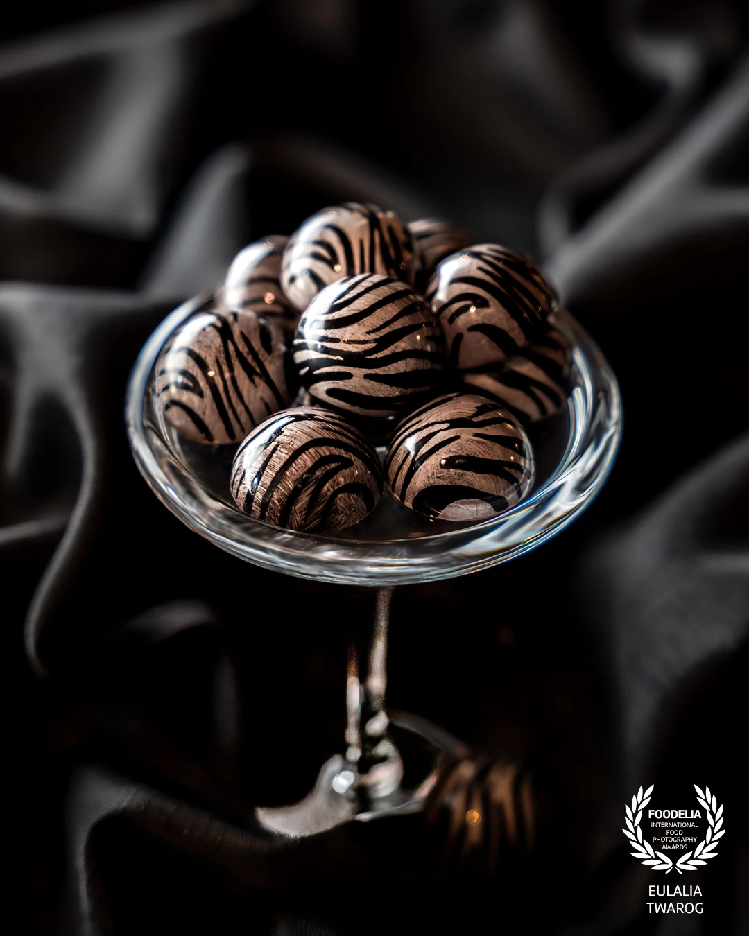 This is a photo of pralines by @kevinkugelchocolatier.<br />
<br />
The praline is called “Miso Caramel” – a milk chocolate shell filled with a self-made cocoa and vanilla miso, which we created together with our partner @schwarzwaldmiso. The technique is a special airbrush stamp look using natural colors. For a very exclusive event, we wanted to create an extraordinary flavor composition and combined Asian-spicy notes with sweet caramel.<br />
<br />
All our ingredients are of the highest quality, and we use only cocoa from fair and sustainable sources – here we work with our partner @original_beans.<br />
<br />
#kevinkugelchocolatier #schwarzwaldmiso #originalbeans
